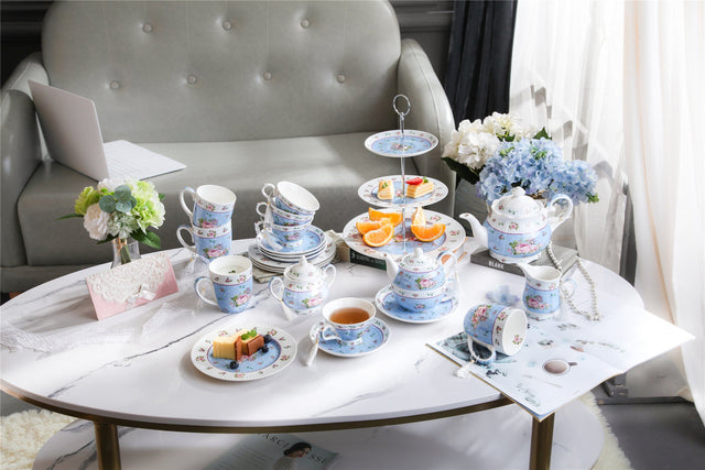 Elegant tea set display featuring a Sugar Bowl and assorted pastries on a stylish coffee table