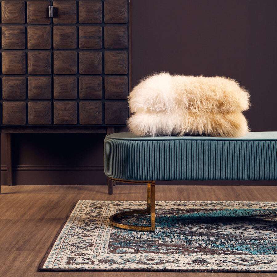 Orsina Teal Rug with Intricate Patterns, placed under a stylish seating area