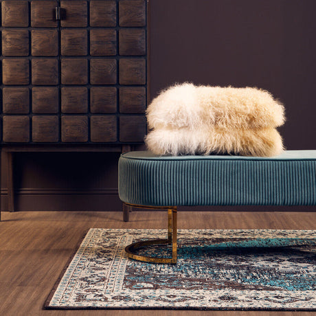 Orsina Teal Rug with Intricate Patterns, placed under a stylish seating area