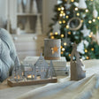 Set of decorative candle holders featuring woodland themes designed for tealight candles in a festive Christmas setting