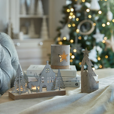 Set of decorative candle holders featuring woodland themes designed for tealight candles in a festive Christmas setting