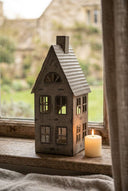 Shades 4 Seasons Tealight Holder in a house design with candle glowing on a wooden window sill