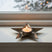 Stylish silver star tealight holder with a candle, perfect for festive Christmas decor
