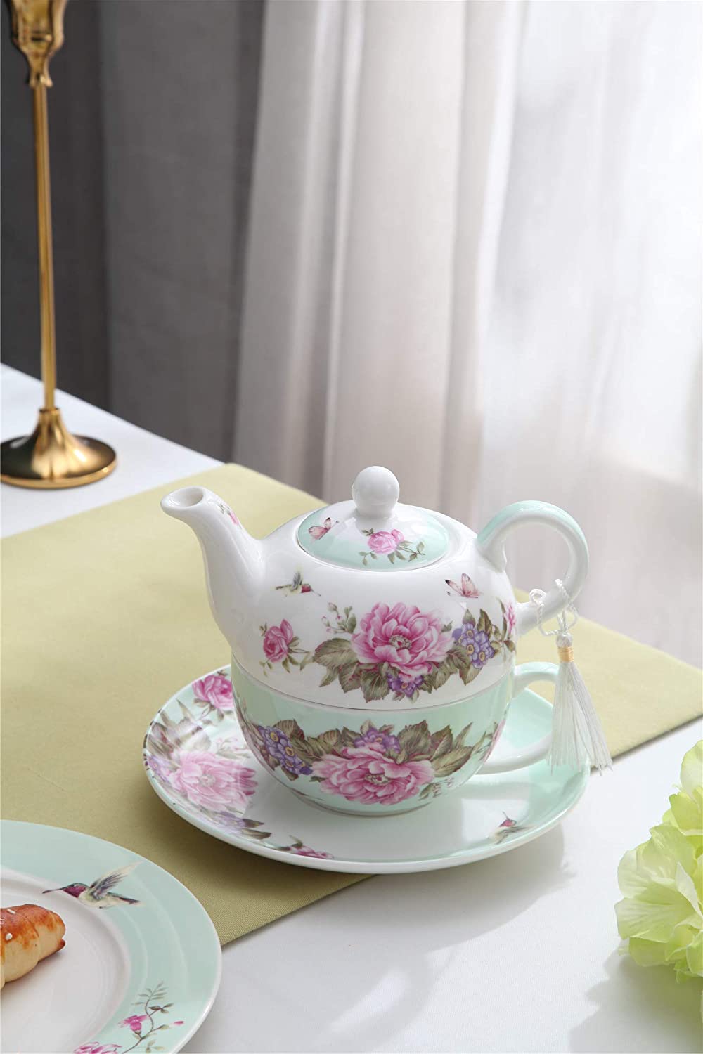 Elegant floral teapot with a matching saucer from London Boutique Lifestyle for tea lovers