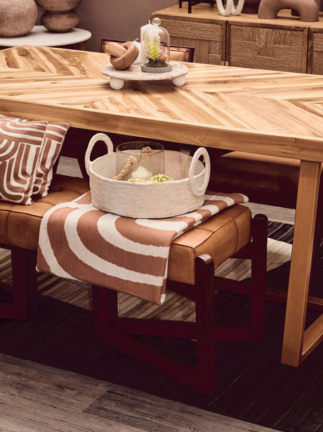 Orsina Terracotta Throw draped over a bench, complementing earthy decor and wooden furniture