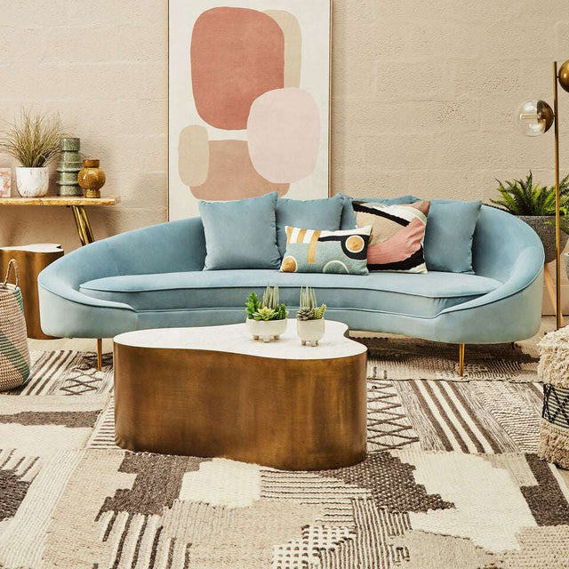Stylish Orsina Textured Rug featuring geometric patterns under a modern curved sofa