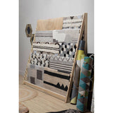 Collection of Orsina Textured Rugs displayed on a wooden stand showcasing various patterns and colours