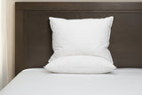 White Pillow from PillowPillow on a bed with a wooden headboard for comfort and support