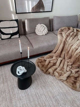 Luxurious Nisu Home faux fur throw draped over a plush sofa for elegant living room decor