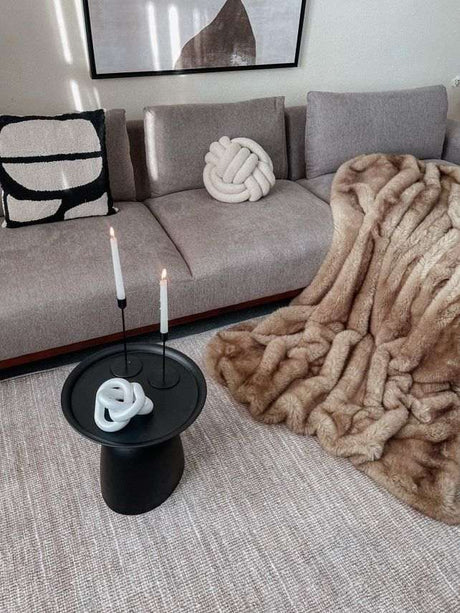 Luxurious Nisu Home faux fur throw draped over a plush sofa for elegant living room decor