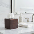 Orsina Tissue Box in brown leather design on a bathroom countertop with towels and soap dispenser