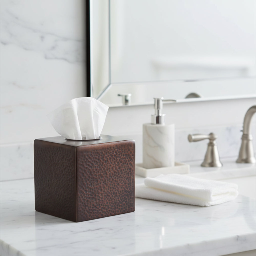 Orsina Tissue Box in brown leather design on a bathroom countertop with towels and soap dispenser