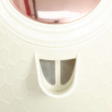 Close-up view of a stylish toaster set with a unique honeycomb design in ivory and rose gold