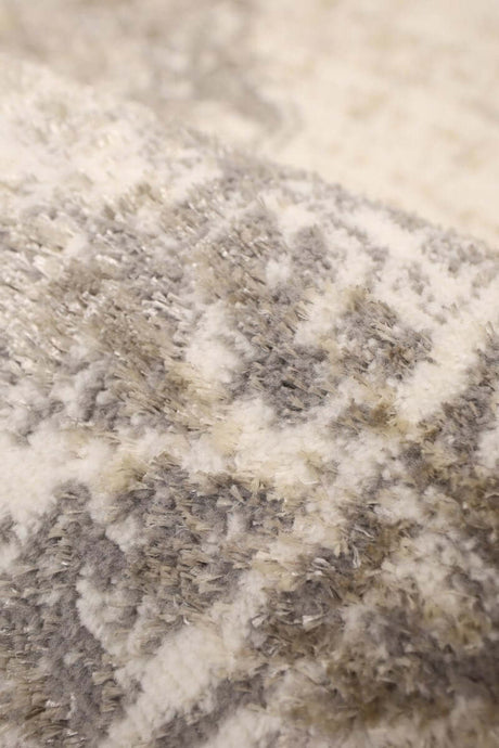 Close-up of a soft Traditional Rug with intricate grey and cream patterns for elegant home decor