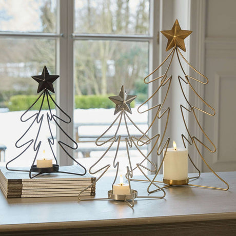 Stylish Christmas candle holders featuring tree and star designs in various sizes for festive decor