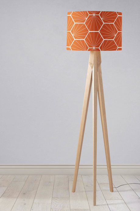 Stylish Shadow Bright lampshade in orange geometric pattern on a wooden tripod floor lamp
