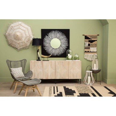 Stylish living room featuring the Trenza Rug on the floor with decorative wall art and furniture