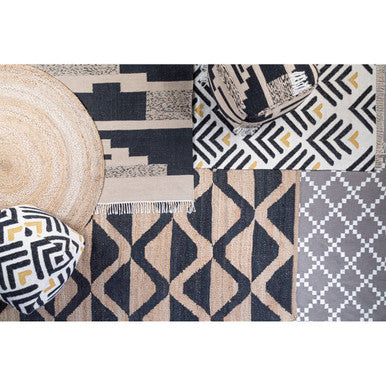 Orsina Trenza Rug featuring geometric patterns in black, cream and gold tones for stylish home decor