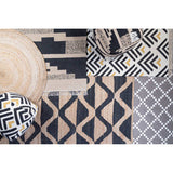 Orsina Trenza Rug featuring geometric patterns in black, cream and gold tones for stylish home decor