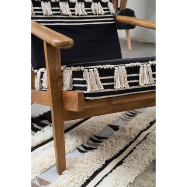 Orsina Tribal Rug with intricate patterns under a stylish wooden chair in a modern interior