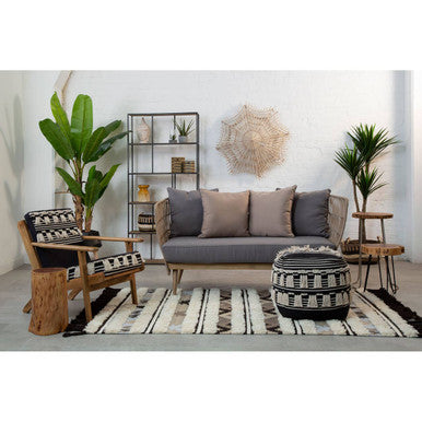 Orsina Tribal Rug featured in a stylish living room with modern furniture and greenery.