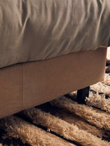 Orsina Tribal Rug featuring soft, textured fibres under a bed for a cozy home aesthetic