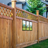 SunCatcher-UK garden mirror set mounted on a wooden fence, enhancing outdoor space aesthetics
