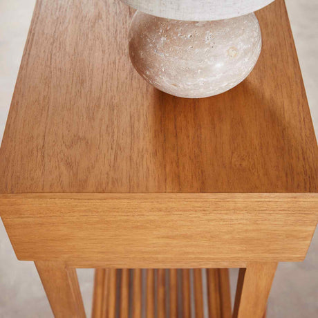 Fishe and Lilly Console Table with a smooth wooden surface and a decorative lamp on top