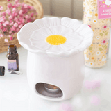 Ceramic flower-shaped oil burner in pastel pink with a yellow centre for fragrant essential oils