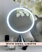 Hollywood Mirrors Vanity Mirror with Cool Lights and Elegant Floral Arrangement