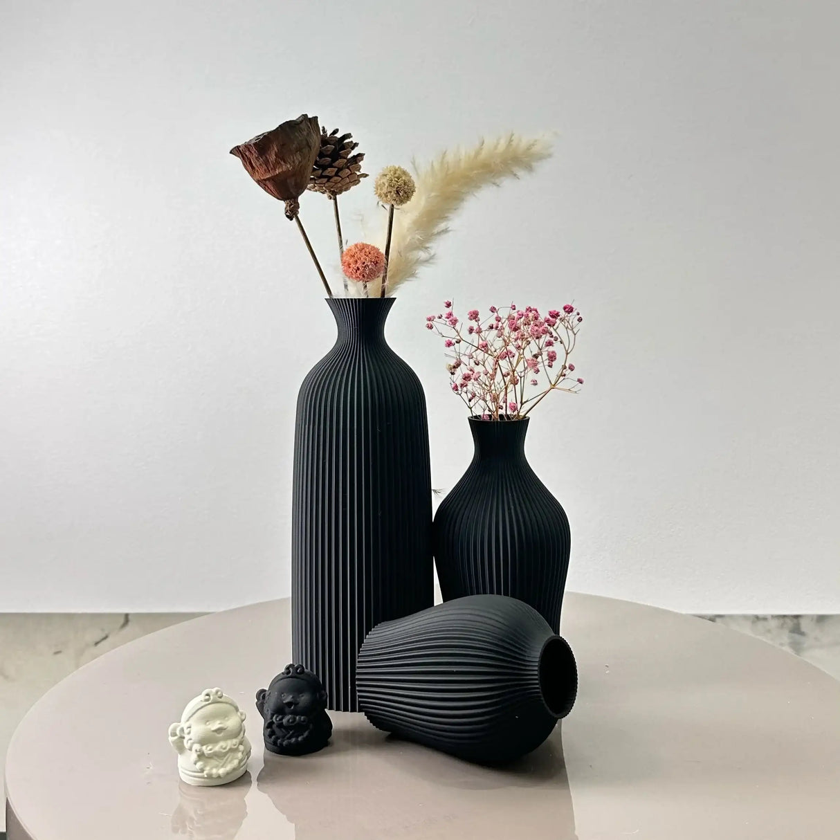 Elegant Nisu Home black vases with textured design and dried flowers for modern decor