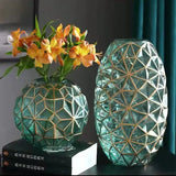 Unique geometric glass vase with gold accents, perfect for floral arrangements