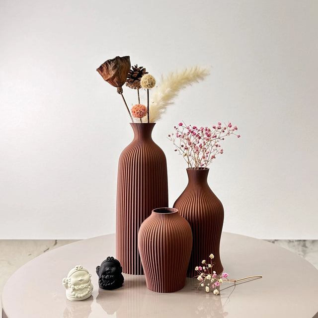 Set of three ceramic vases in terracotta with ribbed design for elegant floral displays
