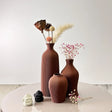 Stylish Nisu Home vase set in brown with textured design, perfect for floral arrangements