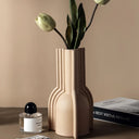 Modern Nisu Home Vase in Beige with Decorative Flowers on a Minimalist Surface
