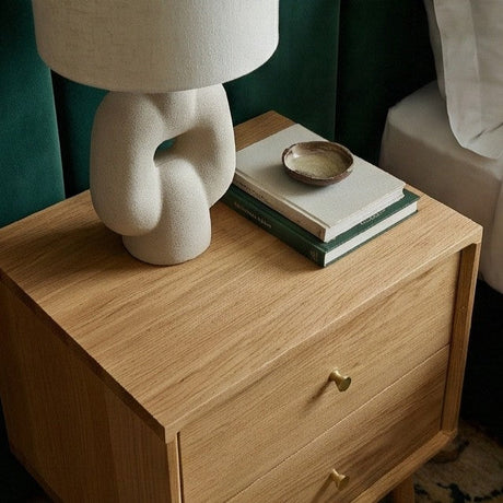 Fishe and Lilly Bedside Table with a stylish lamp and stacked books on top