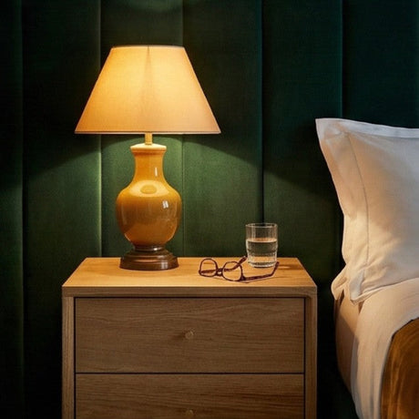 Fishe and Lilly Bedside Table with a lamp, glasses, and a glass of water for a serene bedroom setting