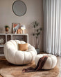 Nisu Home plush chair featuring a soft, round design with a matching ottoman in a modern living room