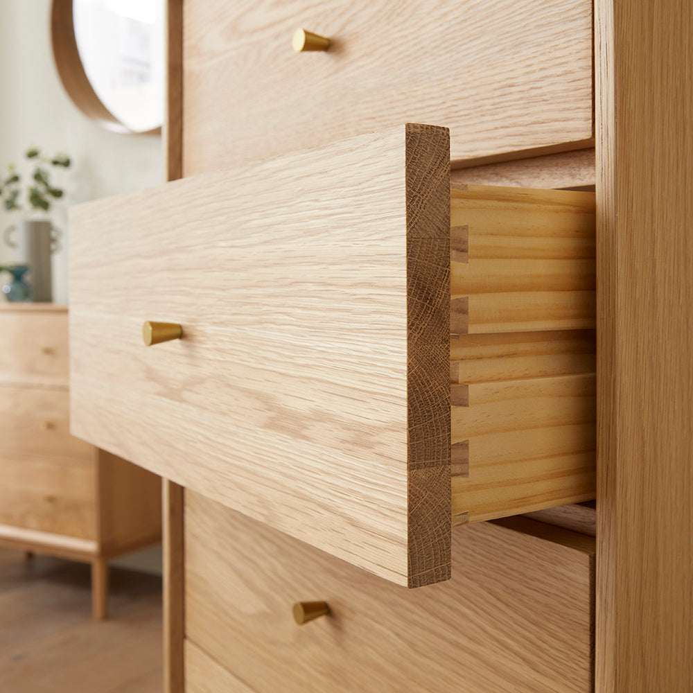 Fishe and Lilly tallboy chest of drawers with natural wood finish and brass handles