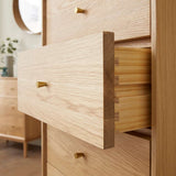 Fishe and Lilly tallboy chest of drawers with natural wood finish and brass handles