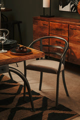 Stylish Orsina Hemp Rug under a wooden dining table with a modern chair, enhancing interior decor