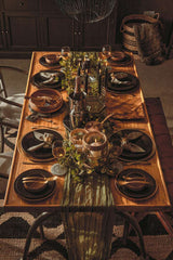 Stylish dining table decorated with a Hemp Rug, elegant tableware, and ambient lighting for gatherings