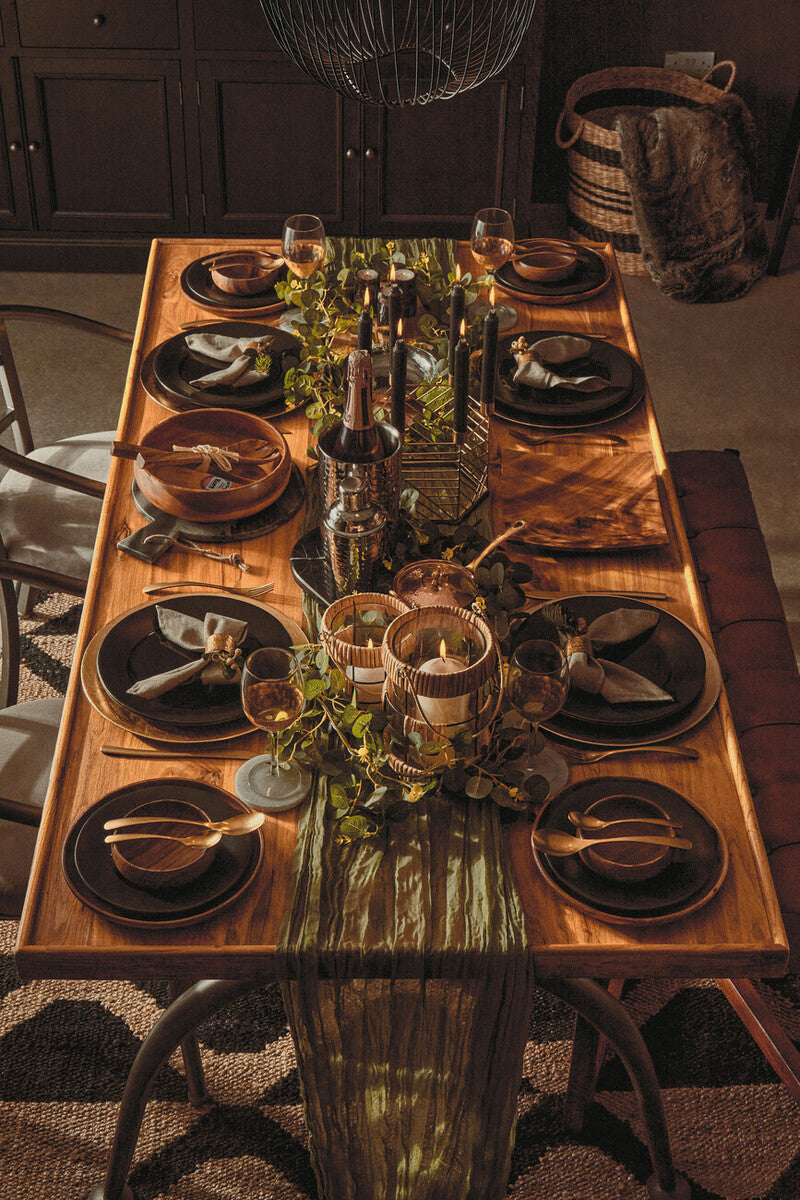 Stylish dining table decorated with a Hemp Rug, elegant tableware, and ambient lighting for gatherings