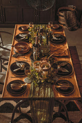 Stylish dining table decorated with a Hemp Rug, elegant tableware, and ambient lighting for gatherings