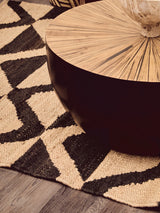 Orsina Hemp Rug featuring a geometric design beneath a wooden coffee table