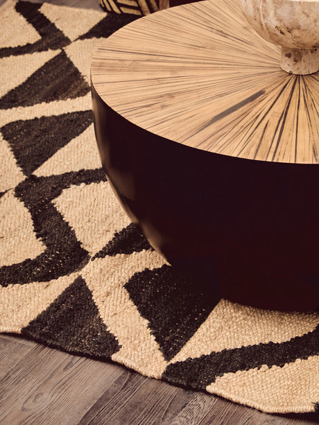 Orsina Hemp Rug featuring a geometric design beneath a wooden coffee table
