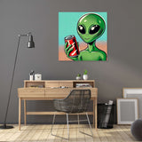 Colourful Wall Art Canvas featuring a green alien holding a soda can in a stylish workspace