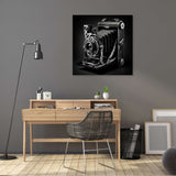 Vintage black and white wall art canvas featuring an old-fashioned camera mounted on a grey wall