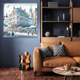 Beautiful Wall Art Canvas depicting a serene city scene with cafes and people in an elegant living room setting