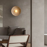 Stylish Light My House Wall Lamp creating warm ambient lighting in a modern living room